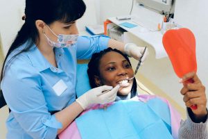 Dentist checking patient’s teeth during dental appointment