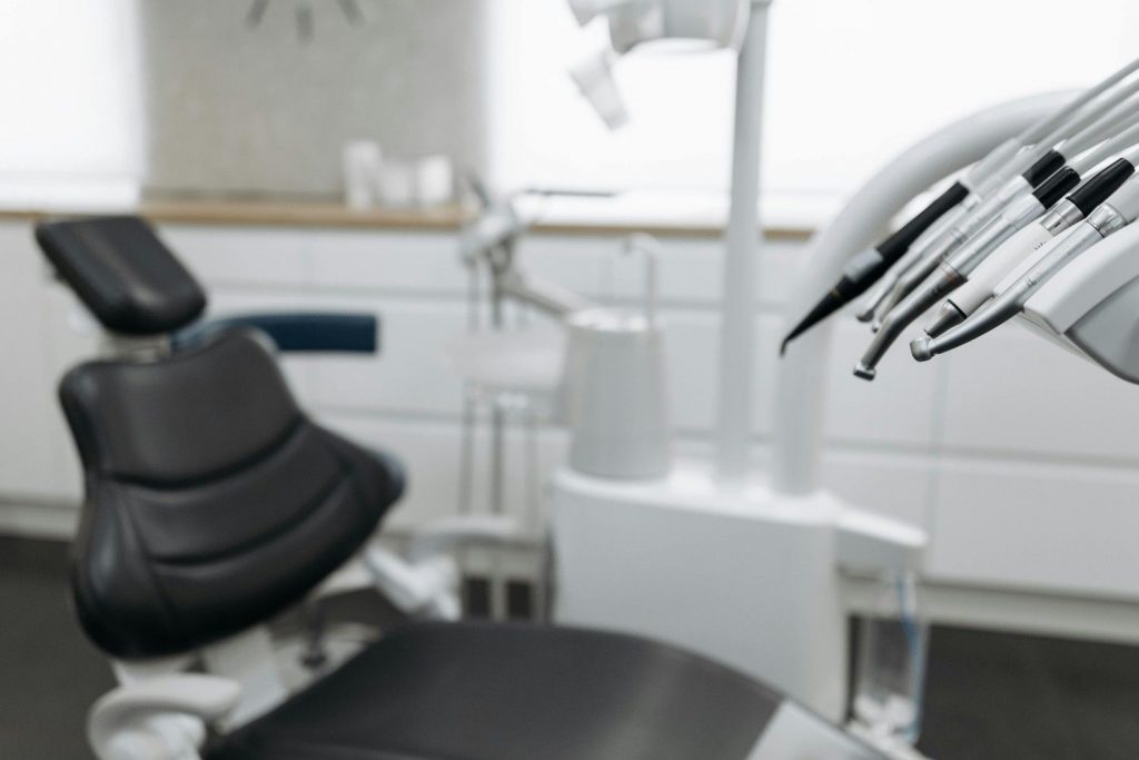 Modern dental chair and equipment prepared for dental treatments