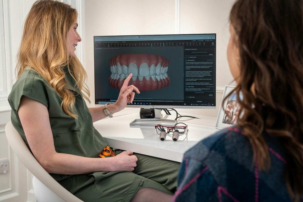 Dentist explaining expected Invisalign results and treatment duration to patient.]