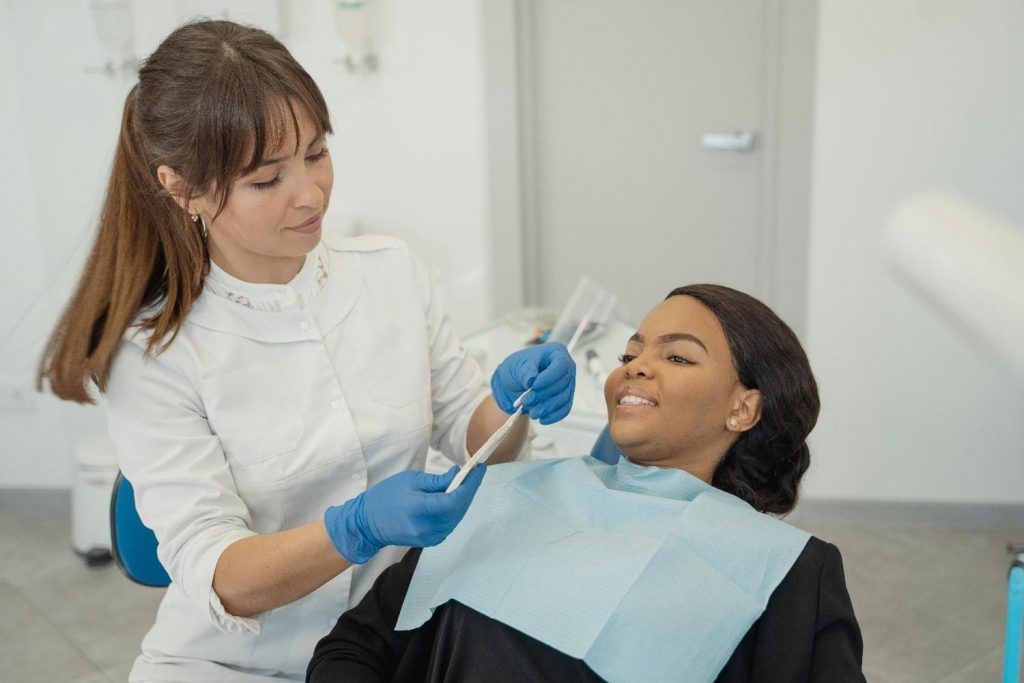 a woman talking with a dentist for dental consultation