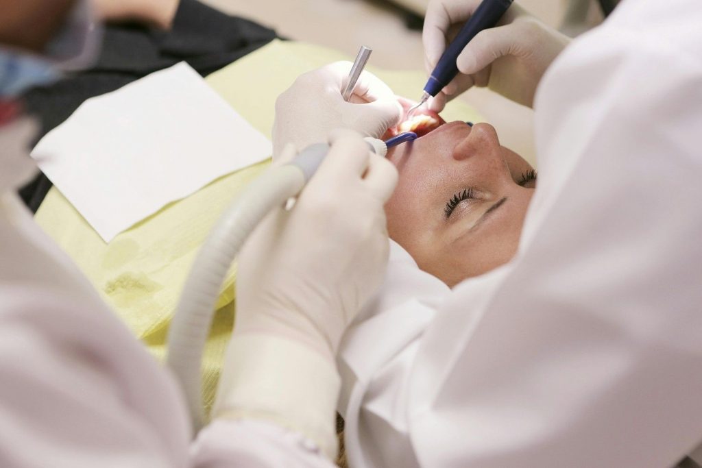 A dentist performing a dental procedure on a patient