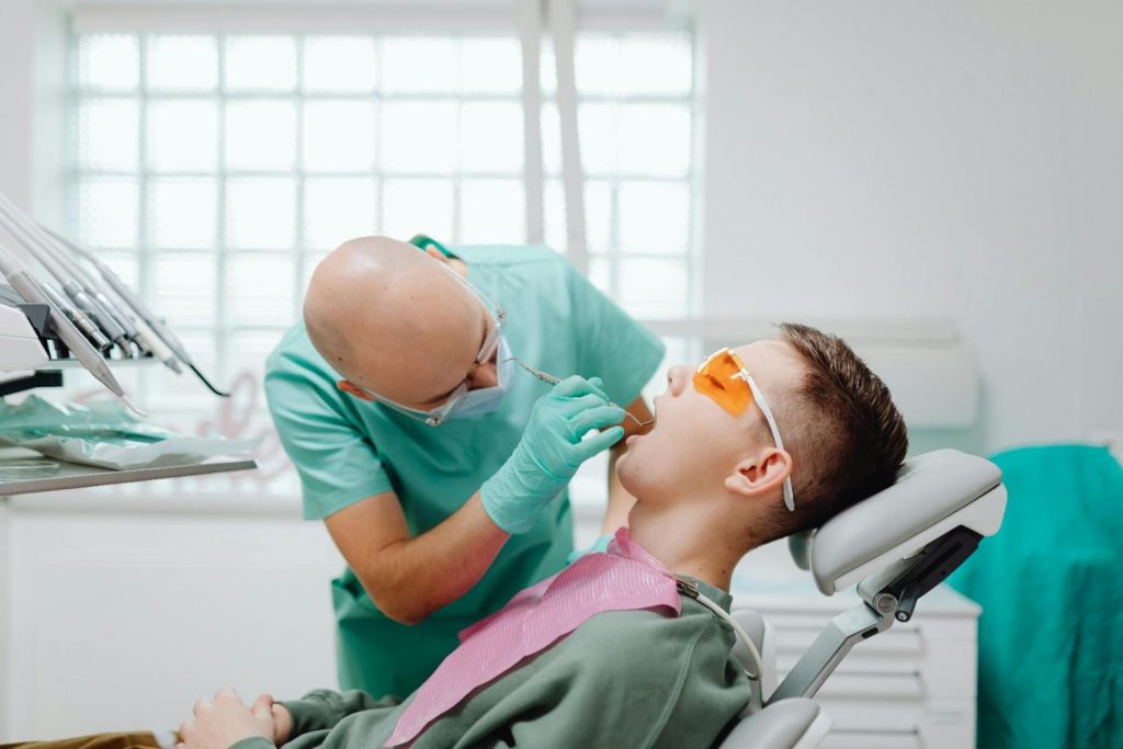 A dentist conducts a dental check-up on a patient
