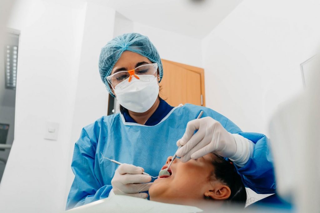 A dentist conducting a dental checkup on a patient