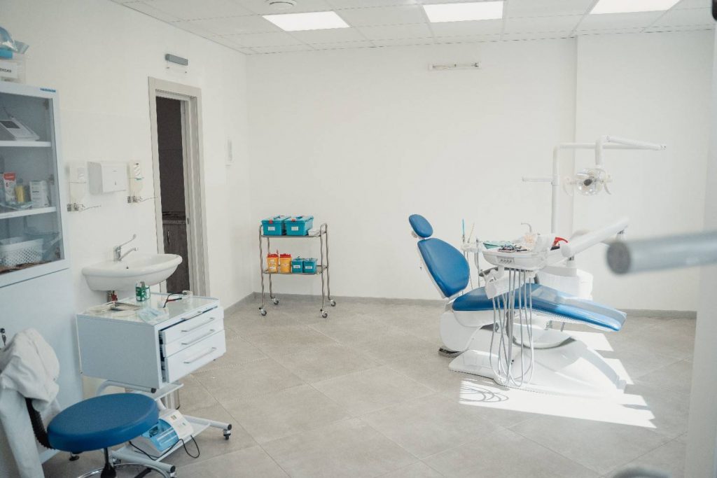 Bright and clean dental clinic interior showcasing a dental chair and equipment